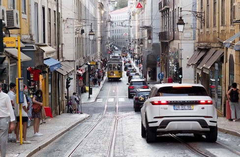 Modern car parked with a city skyline in the background.